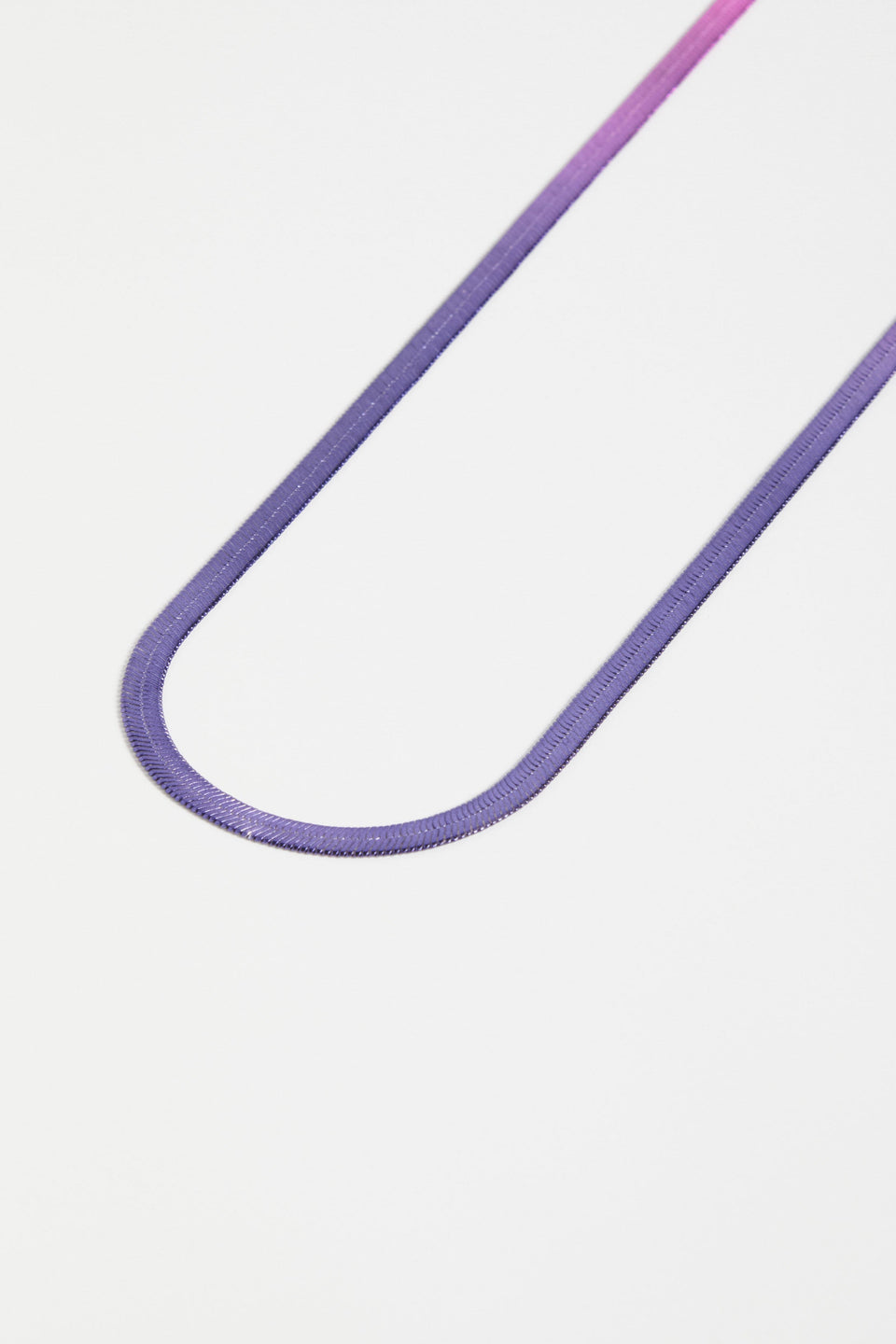 The Vera Long Necklace features a wide, flat snake chain in a shiny ombré finish, adding glistening colour and movement to any look ELK | NAVY-PINK OMBRE