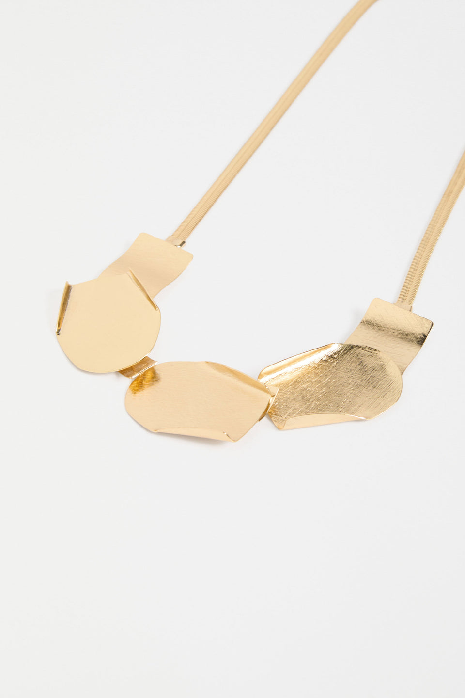 Villt Necklace features sculptural metal shapes with subtle folds and a brushed crosshatched finish for bold, artistic impact ELK  GOLD