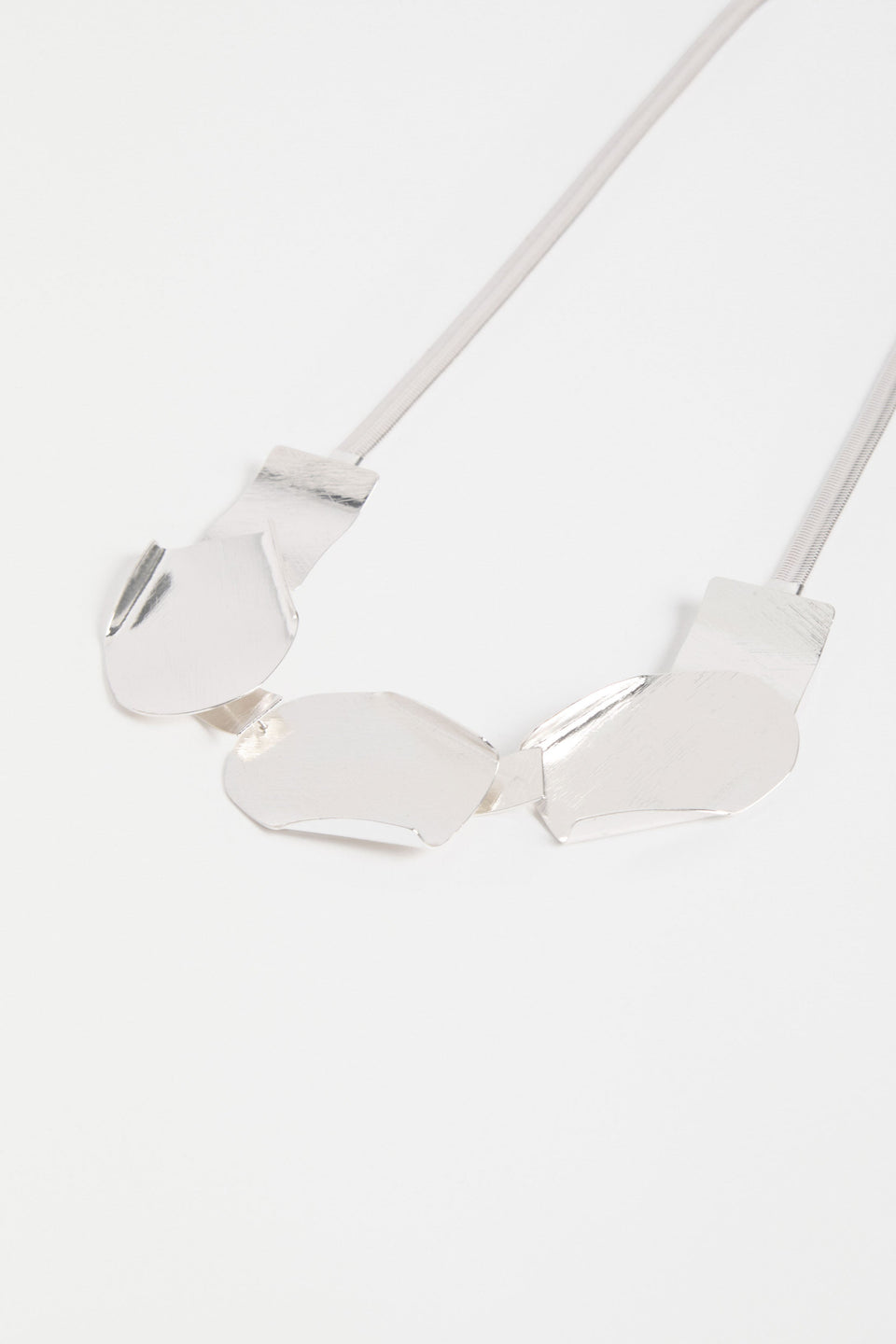 Villt Necklace features sculptural metal shapes with subtle folds and a brushed crosshatched finish for bold, artistic impact ELK | SILVER