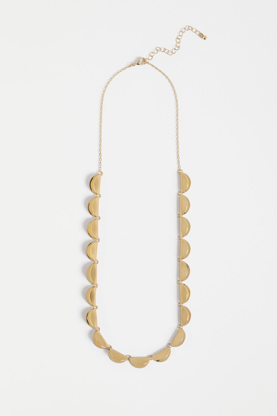 The Fossen Necklace features a row of brushed metal folded discs linked with jump rings on a fine chain ELK | GOLD