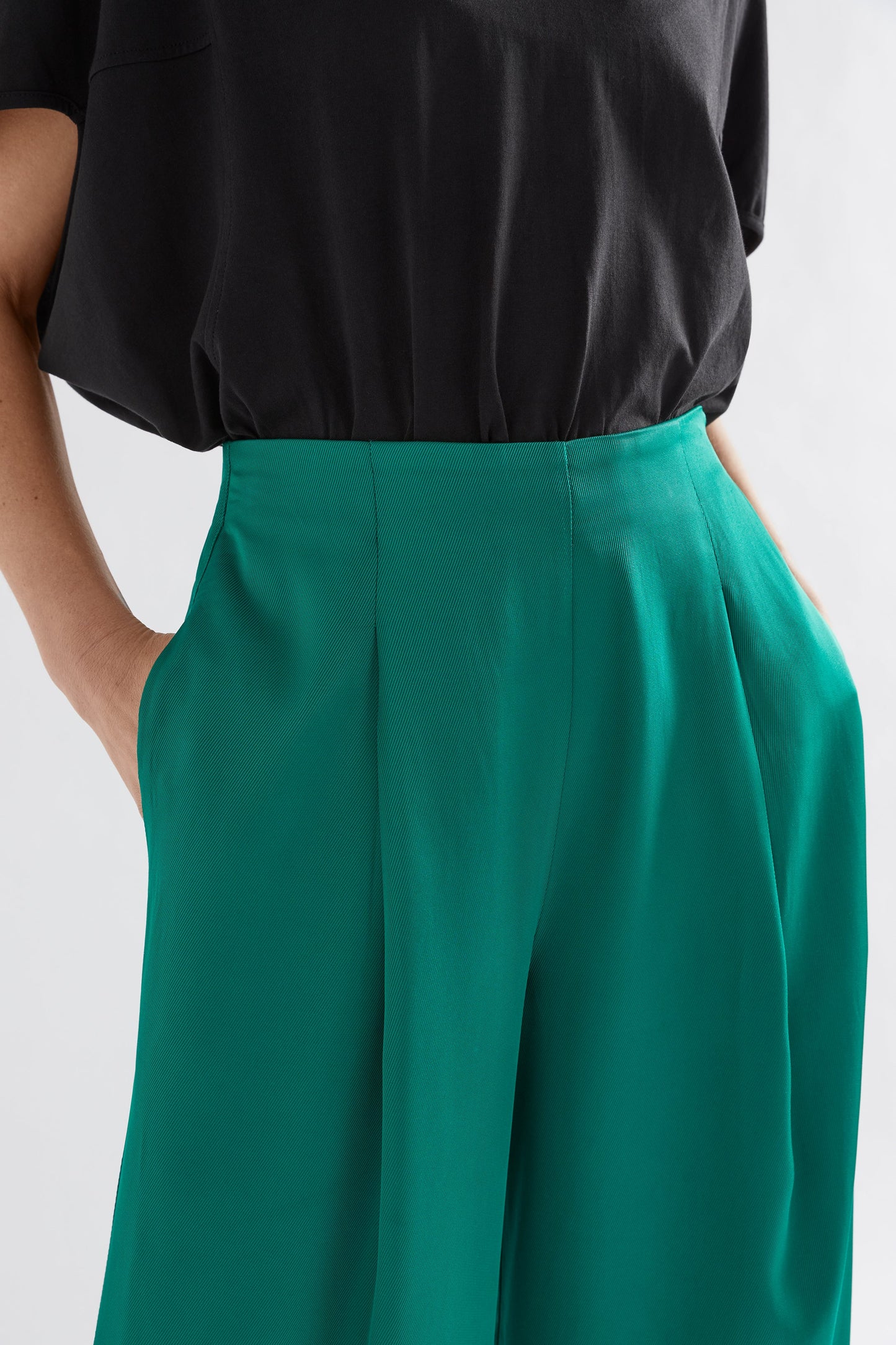 Vail High Waisted Wide Leg Pant Model Front detail with Black Nid Tee | JEWEL GREEN