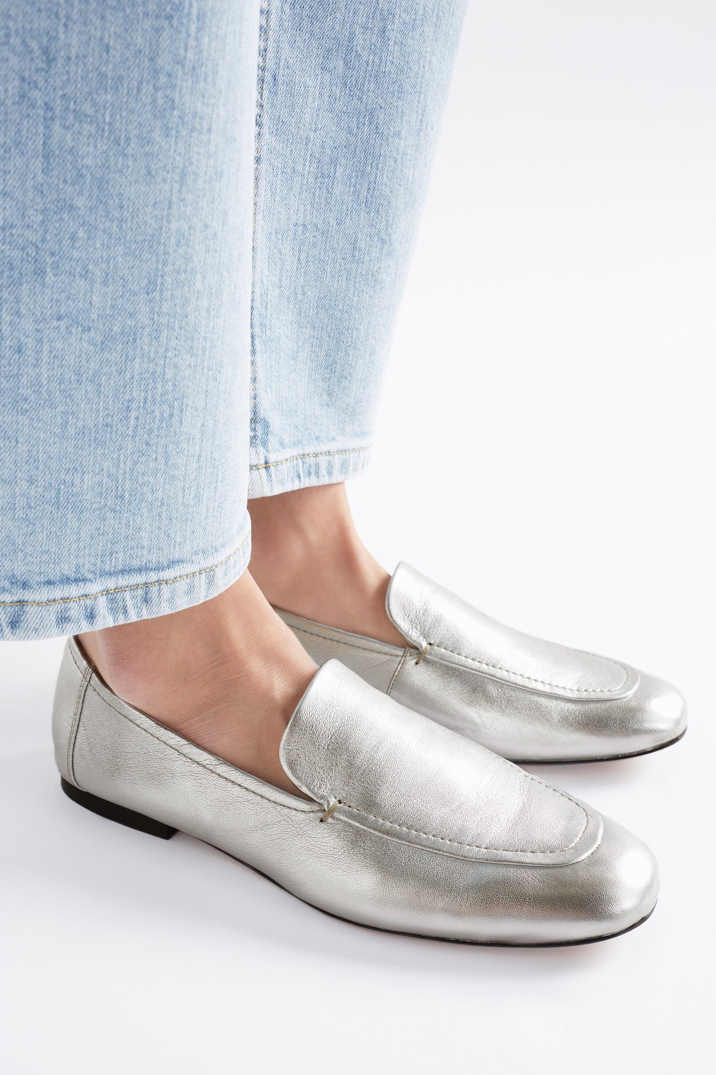 Clift Metallic Silver Leather Flat Loafer Angled Front Model Close up | SILVER