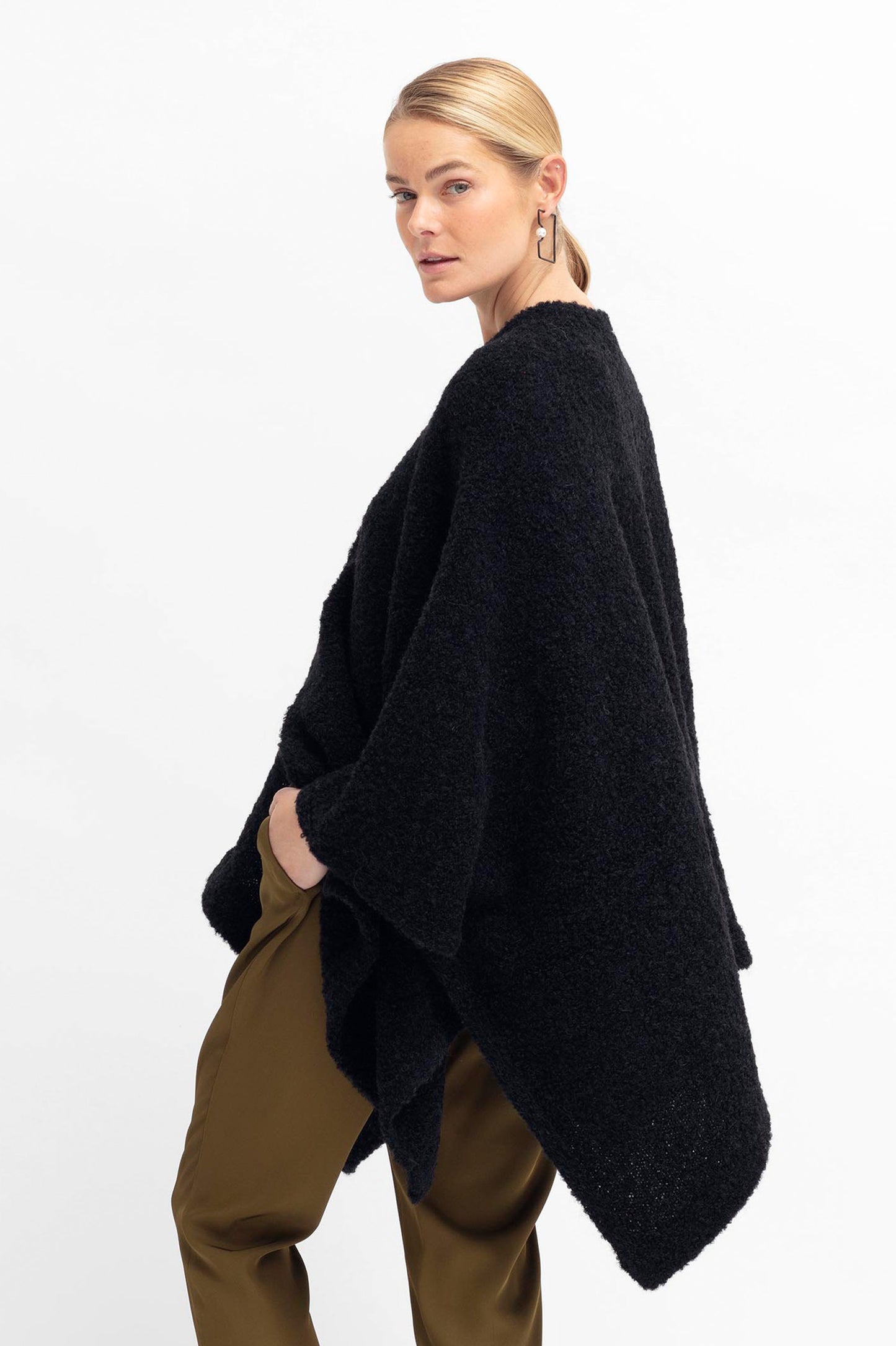 Tukko  Alpaca-Wool Boucle Knit Handkerchief Hem Poncho Wrap Model Angled Back | BLACK