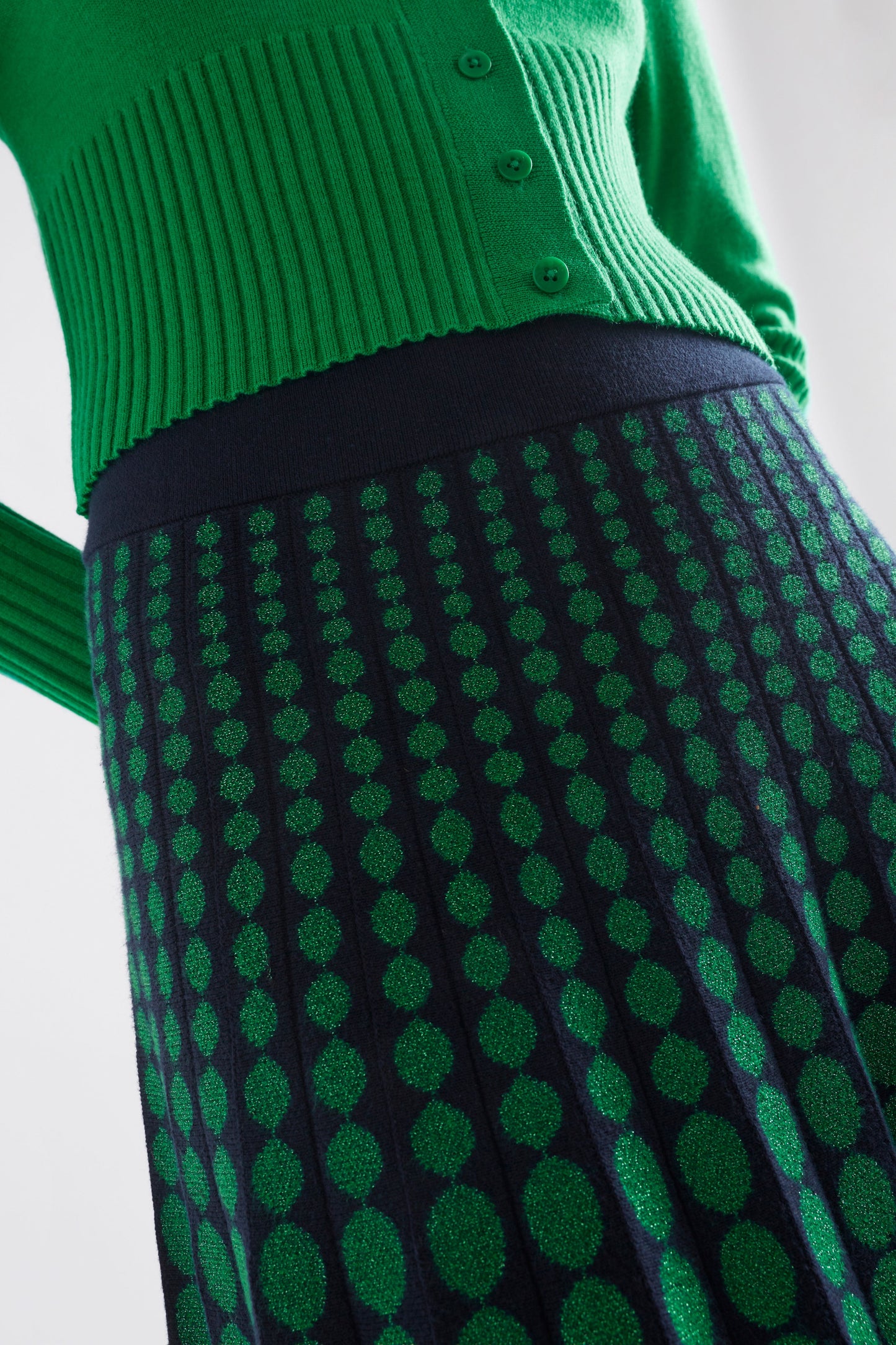 Leira A-Line Midi Metallic Knit Skirt with Circle Design Model Front Detail | NAVY GREEN METALLIC